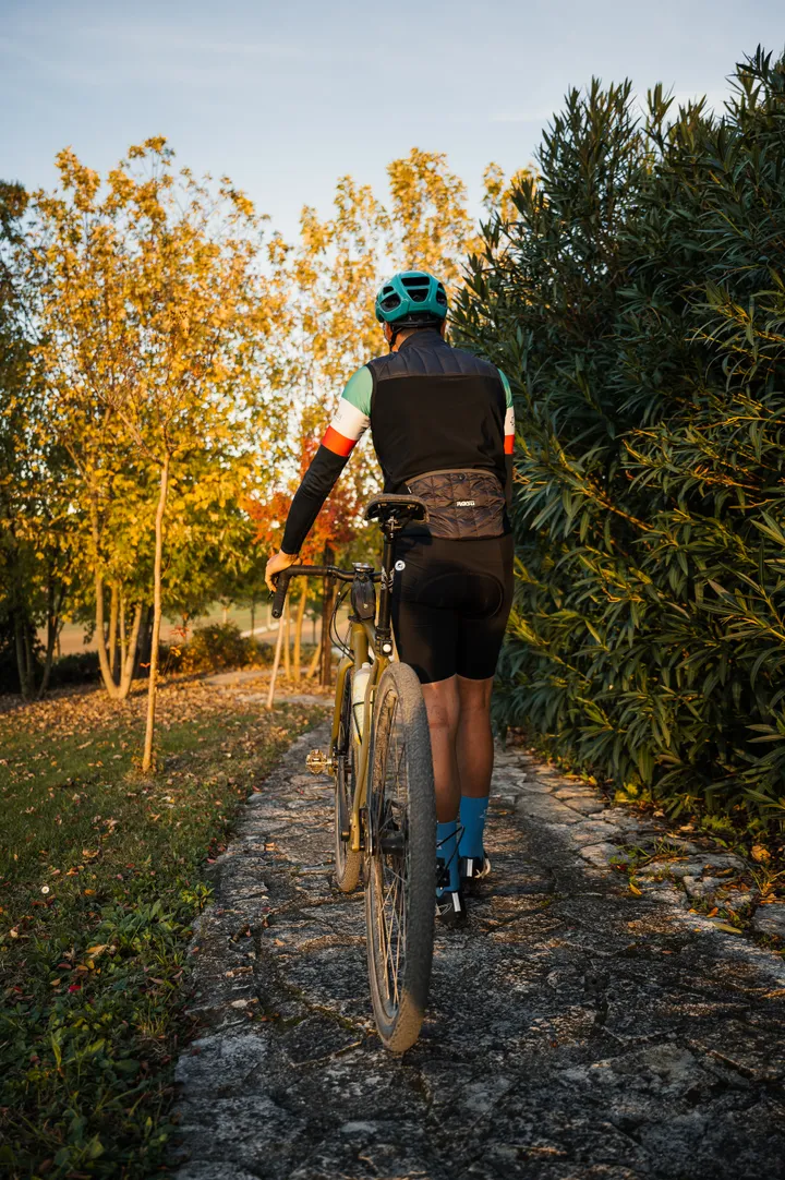 Cyclist on the stone driveway of Ca' Virginia at sunset