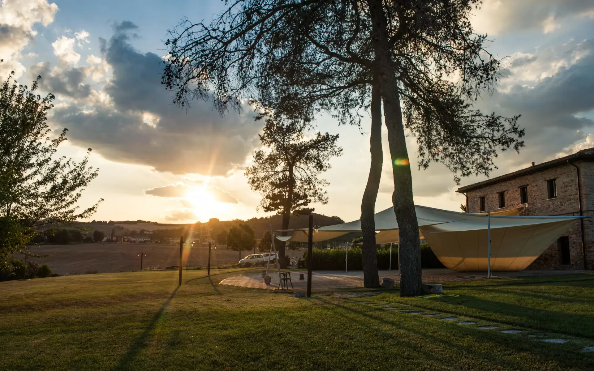 Panoramic pool at sunset surrounded by greenery